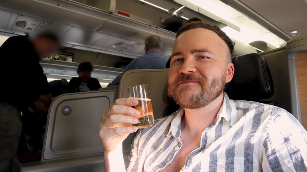 Bradley John drinking on Qantas Business Class